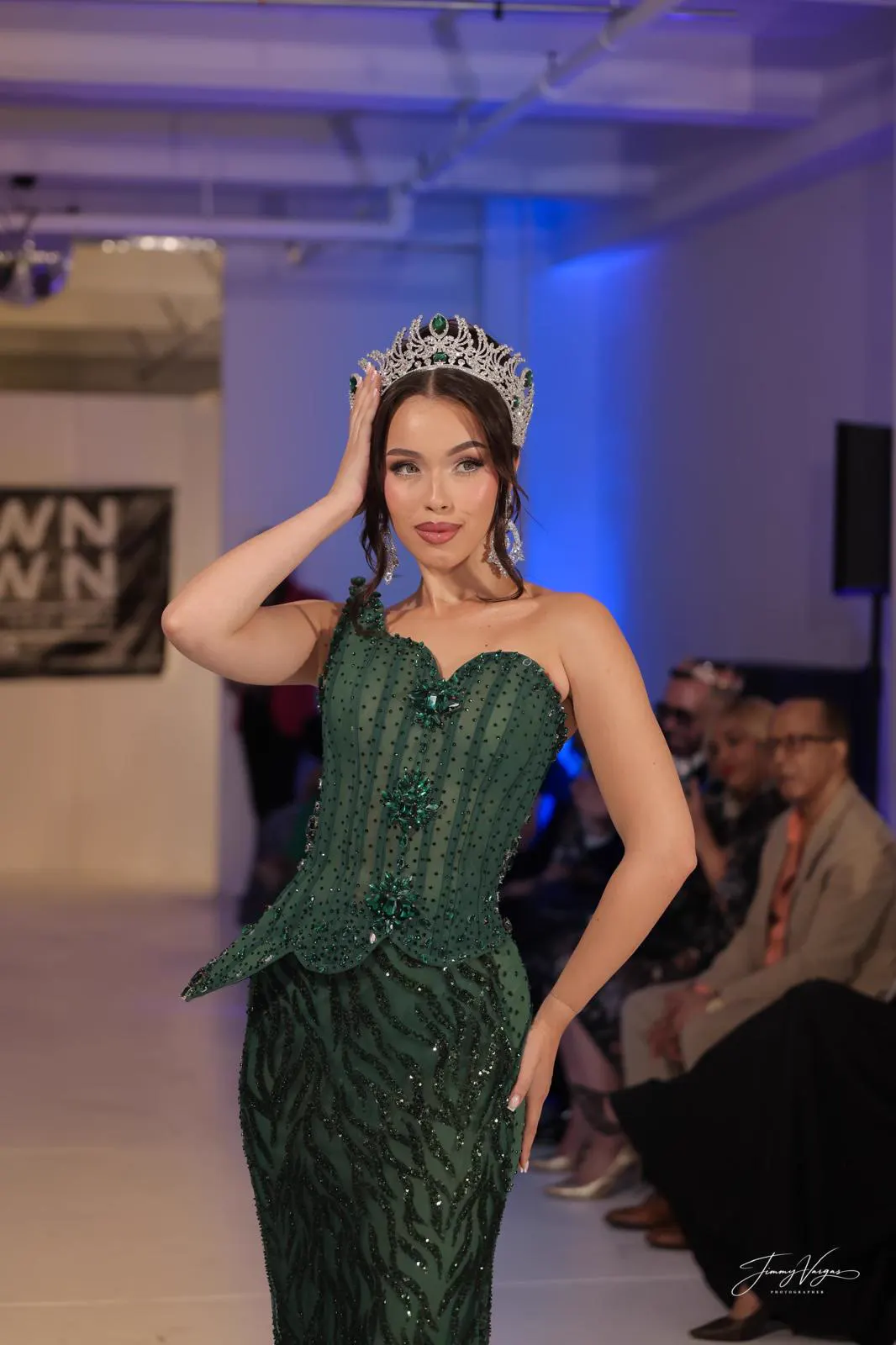 Model in green gown and crown on the Downtown Fashion Week runway
